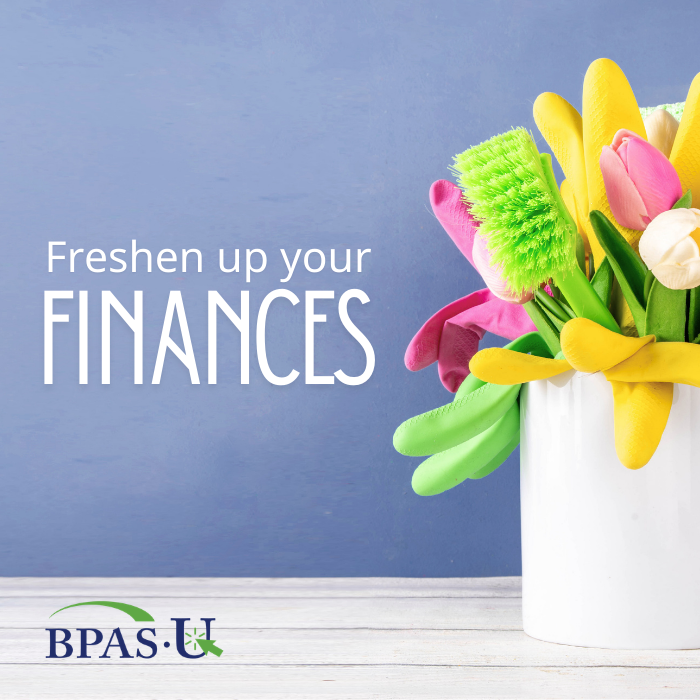 spring cleaning supplies in a bucket. Text overlay "Freshen Up Your Finances"
