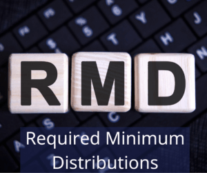 Blocks with letters that read "R" "M" "D" laying on a keyboard. Text overlay: Required Minimum Distributions