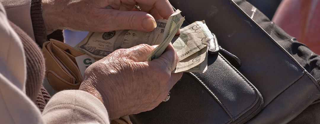 elderly hands holding cash