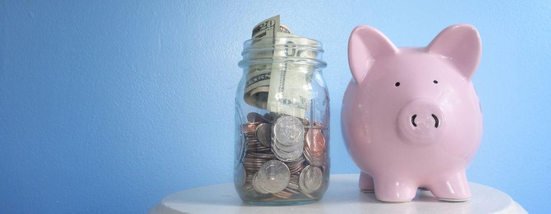 Piggy Bank and savings jar with money in it. Blue background