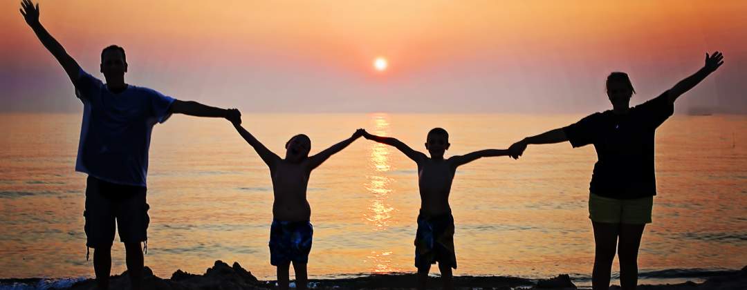 silhouette of family at sunset