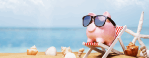 Image of piggy bank sitting at beach